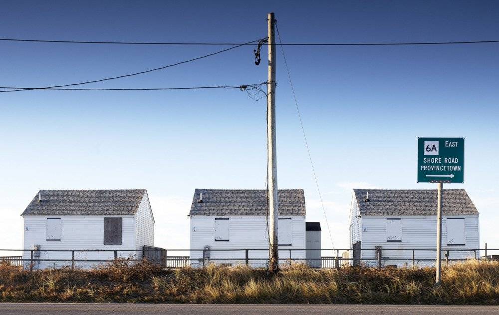 Charming seaside houses in Truro, with weathered shingles and ocean views, nestled along the Cape Cod coastline
