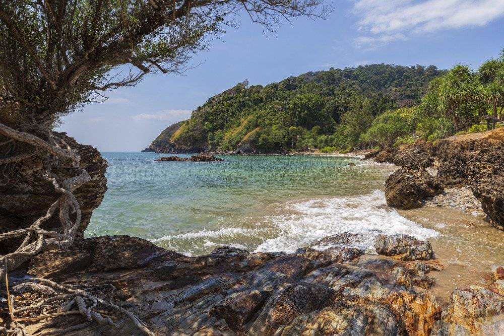 View of the lush greenery, scenic trails, and rocky coastline at Mu Ko Lanta National Park.